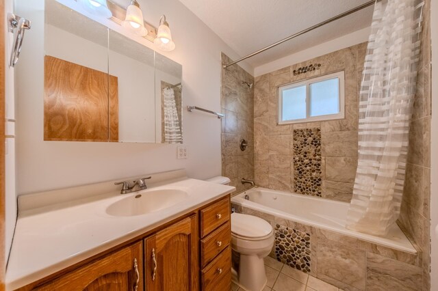 full bathroom with vanity, tile patterned floors, toilet, a textured ceiling, and shower / tub combo with curtain