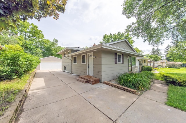 view of front of home featuring a garage and an outdoor structure