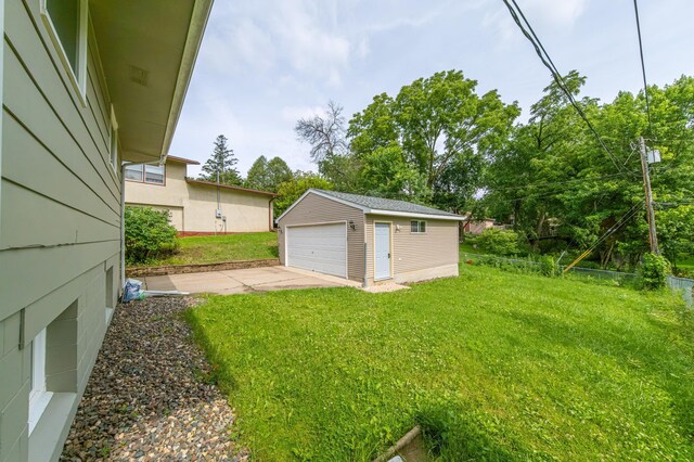 view of yard featuring a garage and an outdoor structure