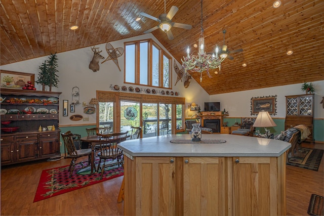 kitchen with hardwood / wood-style flooring, high vaulted ceiling, a kitchen island, and wood ceiling