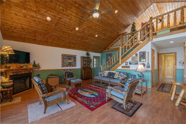 living room with wood-type flooring, ceiling fan, high vaulted ceiling, and wooden ceiling