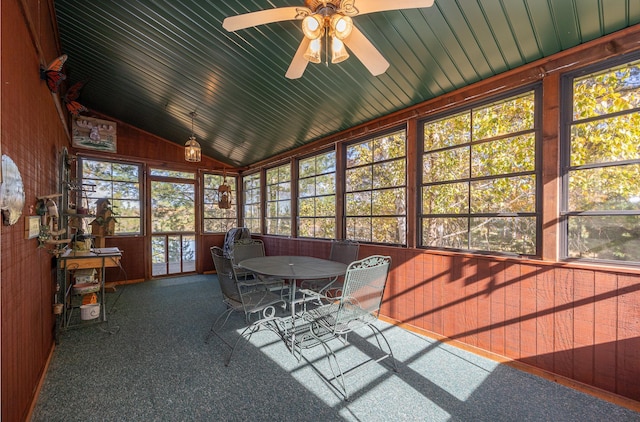 sunroom with ceiling fan, lofted ceiling, and a healthy amount of sunlight