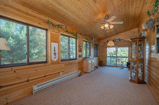 unfurnished sunroom featuring baseboard heating, wood ceiling, vaulted ceiling, and ceiling fan