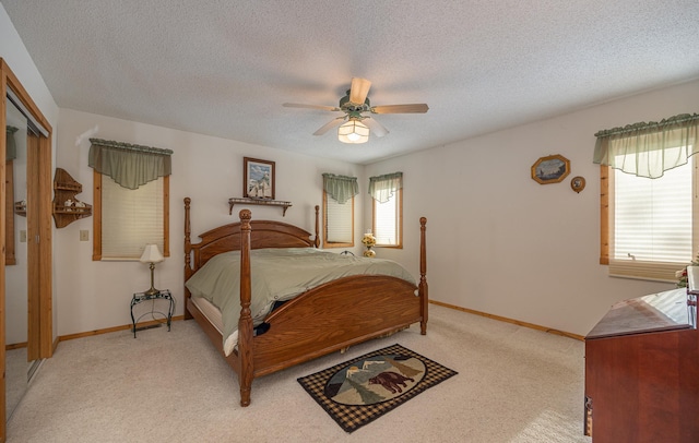 bedroom with multiple windows, ceiling fan, and a textured ceiling