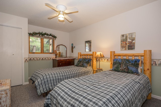 carpeted bedroom with a closet, a textured ceiling, and ceiling fan