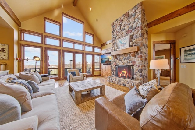 living room with a fireplace, high vaulted ceiling, beam ceiling, and light wood-type flooring