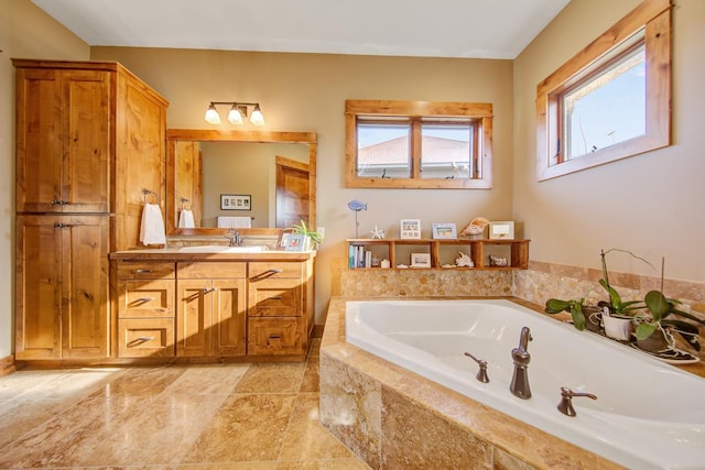 bathroom with a relaxing tiled tub and vanity