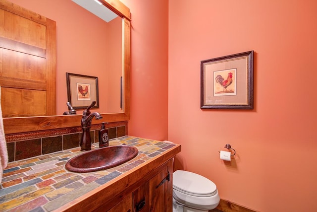 bathroom with toilet and vanity