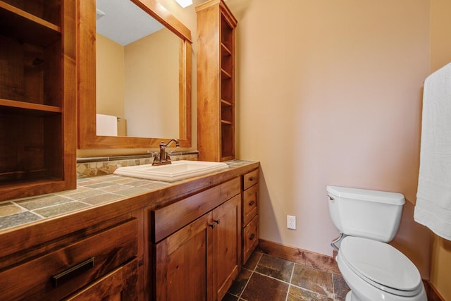 bathroom featuring toilet and vanity