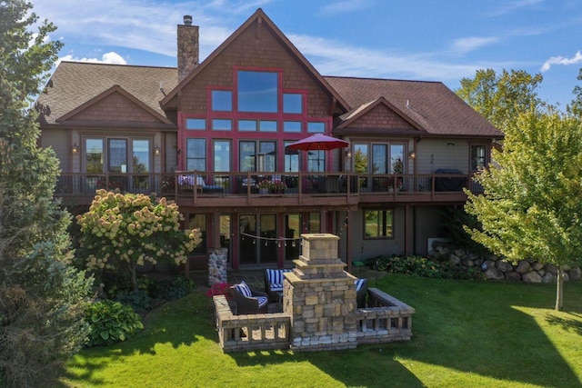 back of property featuring a yard, a wooden deck, and a patio