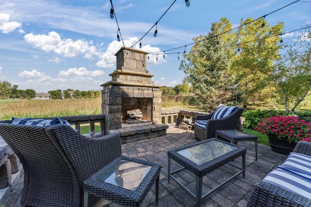 view of patio featuring an outdoor stone fireplace