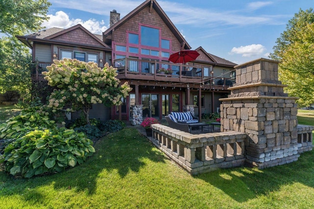 back of house featuring an outdoor hangout area, a deck, a patio area, and a lawn