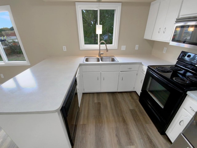 kitchen featuring wood-type flooring, sink, white cabinets, kitchen peninsula, and black appliances