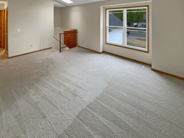 unfurnished room featuring light colored carpet