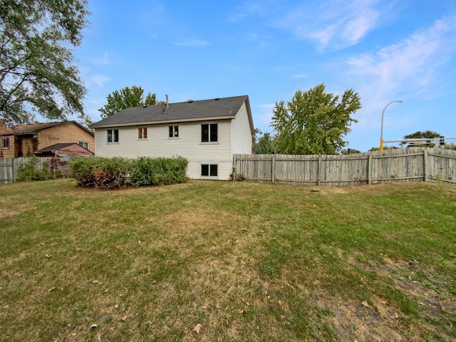 back of house with a yard