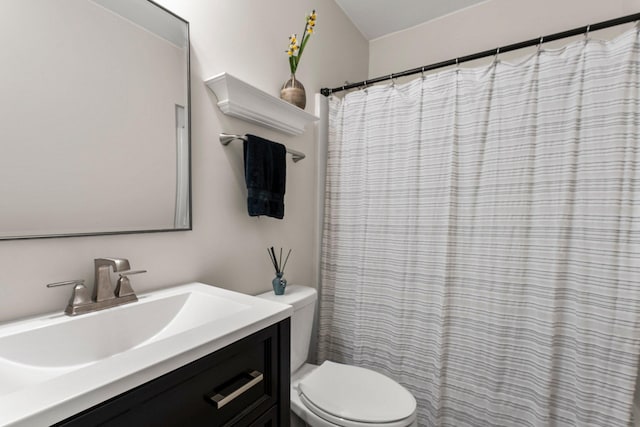 bathroom featuring vanity, toilet, and a shower with shower curtain