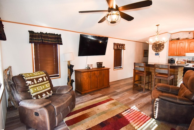 living room with hardwood / wood-style floors, ceiling fan with notable chandelier, and ornamental molding