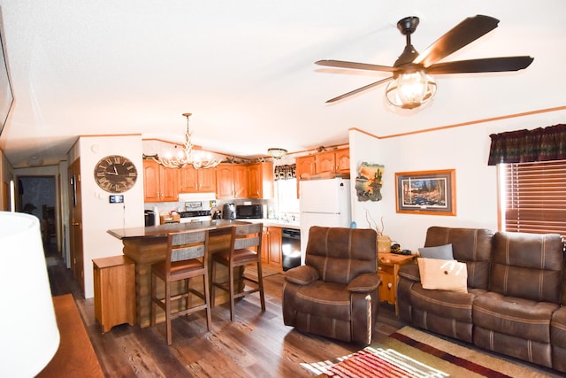 living room featuring ceiling fan with notable chandelier and dark wood-type flooring