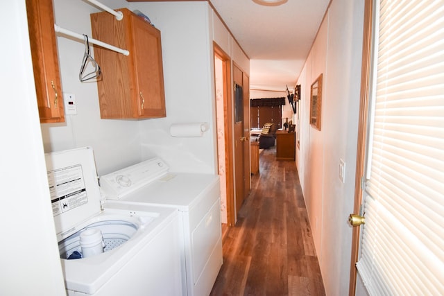 laundry room with cabinets, dark hardwood / wood-style flooring, and washing machine and clothes dryer