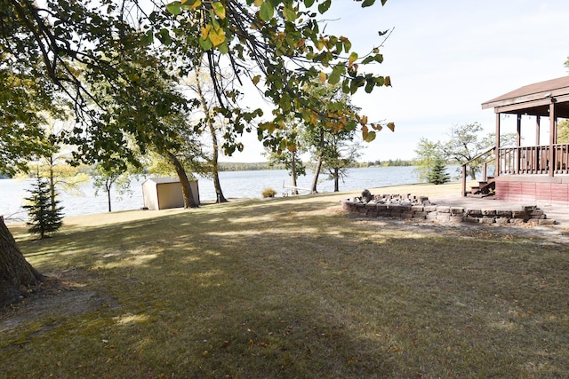 view of yard with a water view and a shed