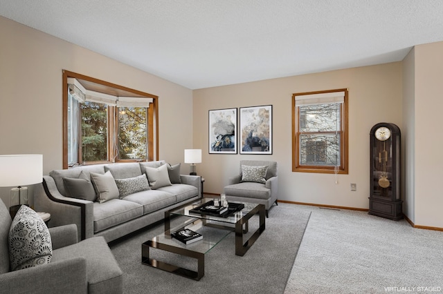 living room featuring light carpet, a textured ceiling, and plenty of natural light