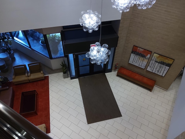 interior space with tile patterned flooring, a high ceiling, and a chandelier