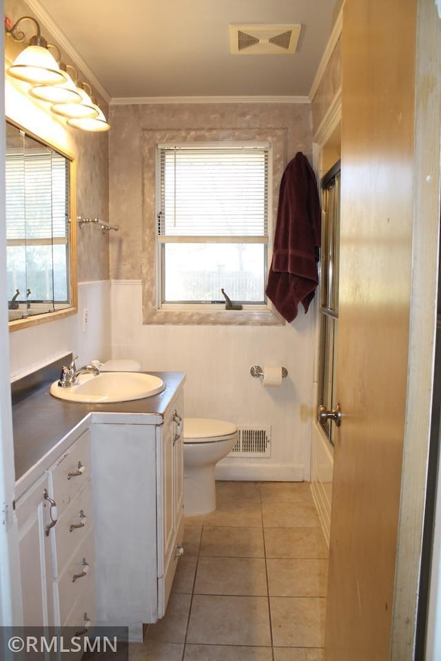 bathroom with tile patterned flooring, vanity, toilet, and ornamental molding