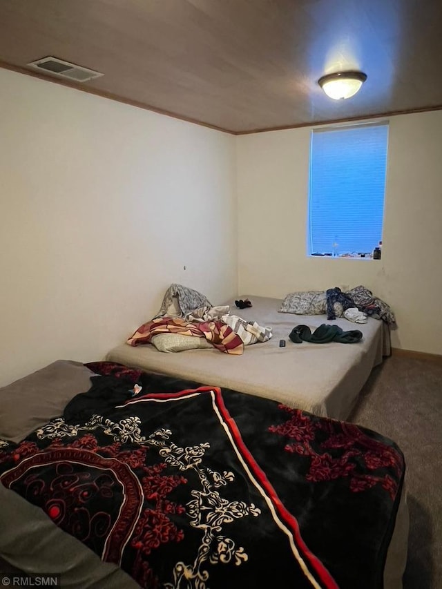 carpeted bedroom featuring ornamental molding