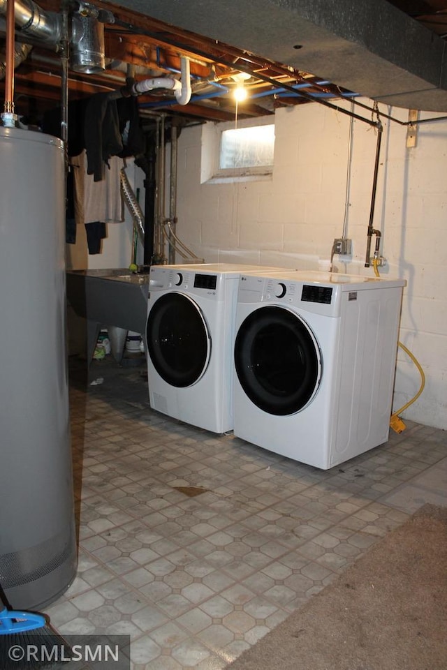 laundry room featuring washer and clothes dryer, sink, and gas water heater