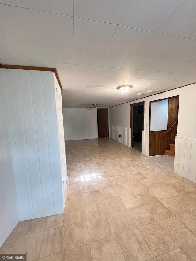 spare room featuring wood walls