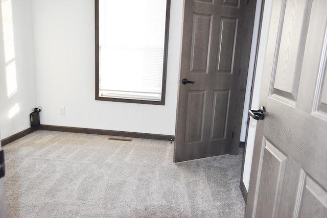 unfurnished room with light carpet