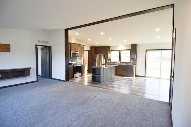 unfurnished living room featuring light hardwood / wood-style floors and lofted ceiling