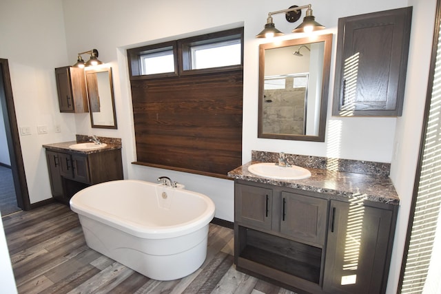 bathroom featuring vanity, hardwood / wood-style flooring, and separate shower and tub