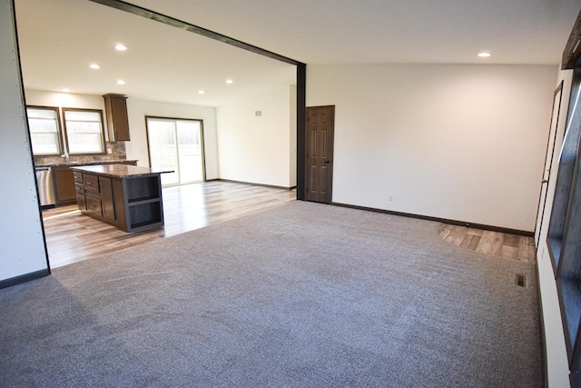 unfurnished living room with light hardwood / wood-style floors and vaulted ceiling