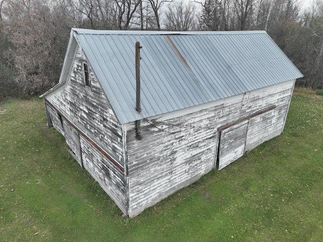 view of outbuilding with a yard