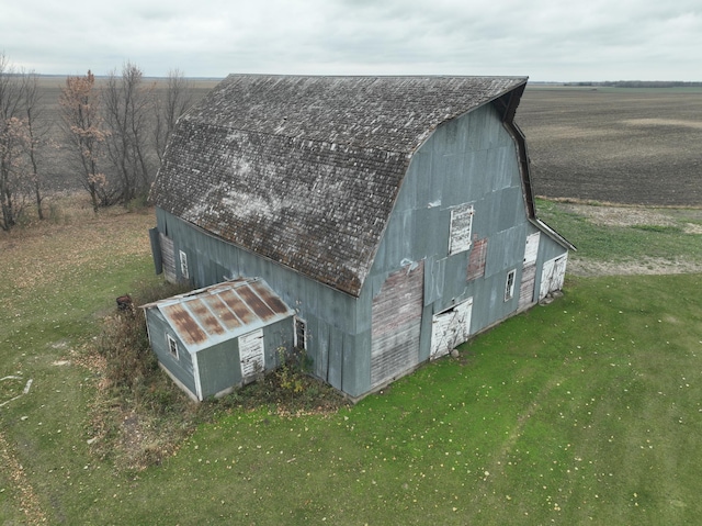 view of outdoor structure with a yard and a rural view