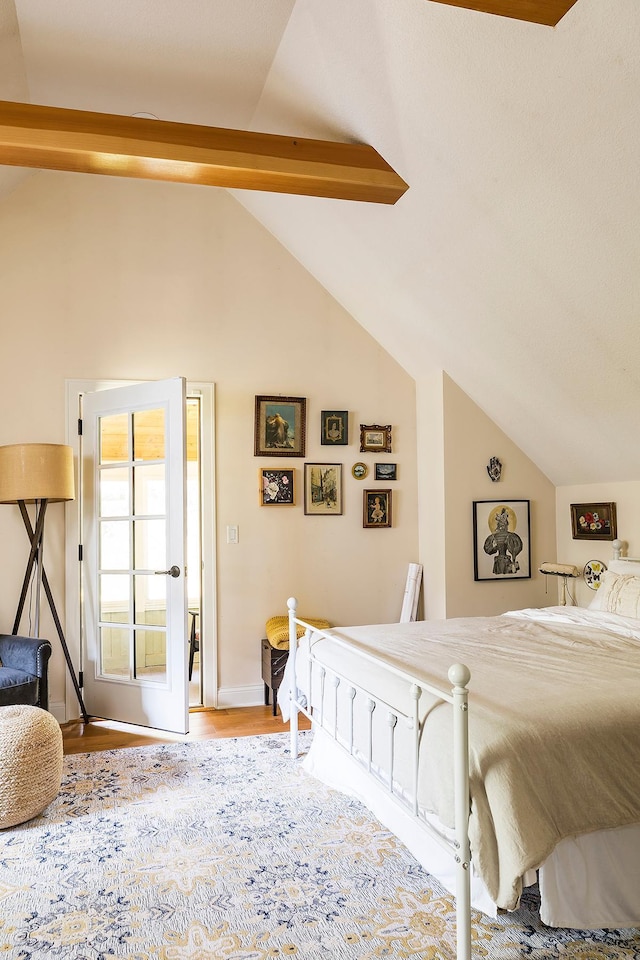 bedroom with hardwood / wood-style floors and lofted ceiling with beams