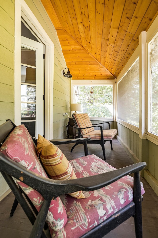 sunroom / solarium featuring a wealth of natural light, vaulted ceiling, and wooden ceiling