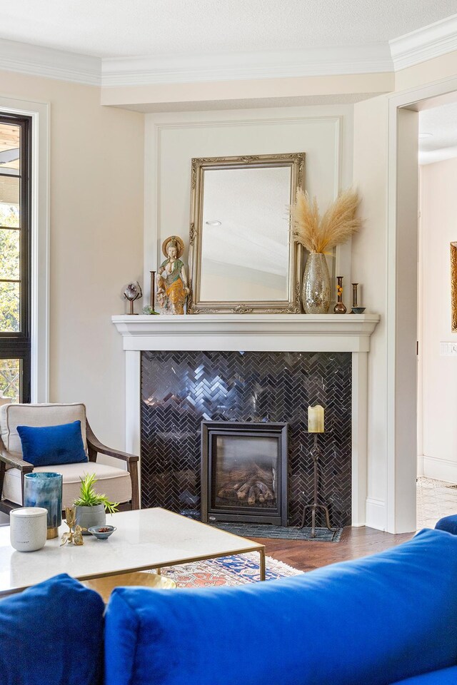 interior space with crown molding, hardwood / wood-style flooring, and a fireplace