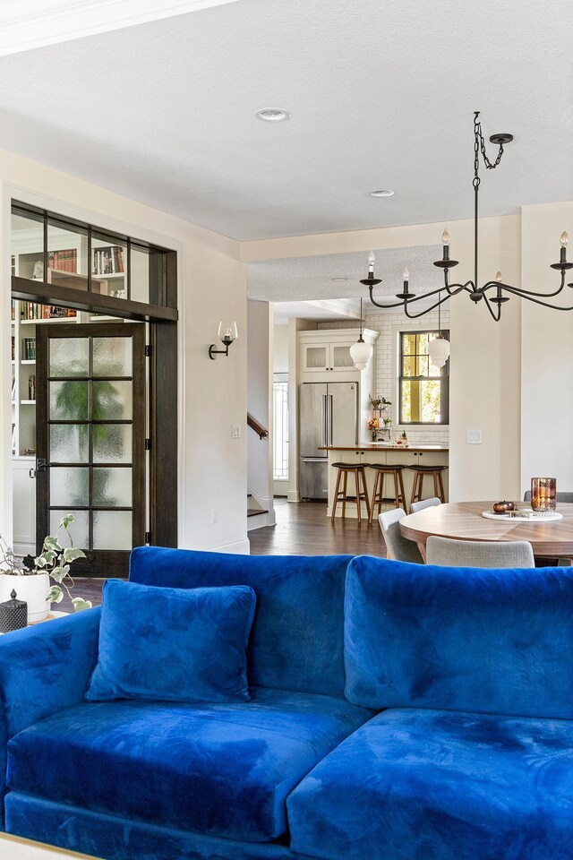 living room featuring an inviting chandelier and hardwood / wood-style flooring