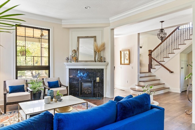 living room featuring a healthy amount of sunlight, a textured ceiling, a fireplace, and hardwood / wood-style floors