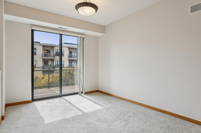 carpeted empty room featuring plenty of natural light