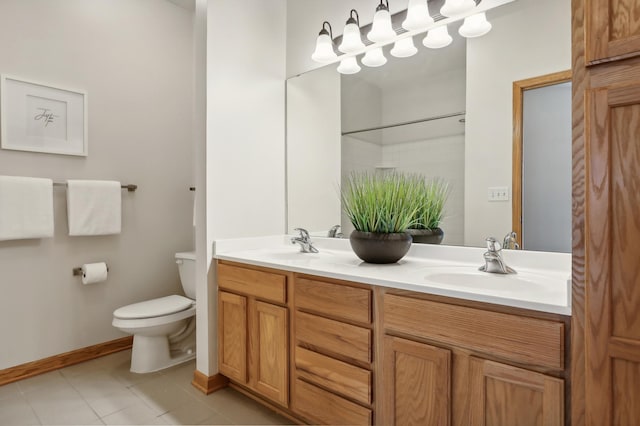 bathroom with tile patterned floors, vanity, toilet, and a shower