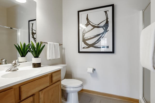 bathroom with a shower with door, tile patterned floors, vanity, and toilet