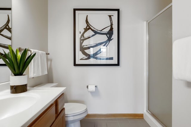 bathroom with vanity, toilet, a shower with door, and tile patterned floors