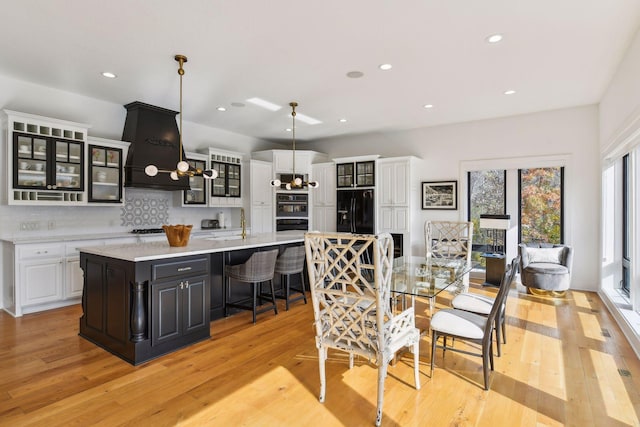 dining room with a notable chandelier and light wood-type flooring