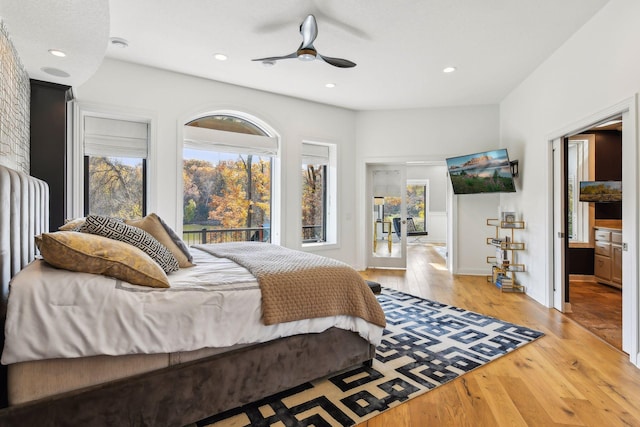 bedroom with access to exterior, light wood-type flooring, and ceiling fan