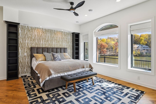 bedroom with ceiling fan and wood-type flooring