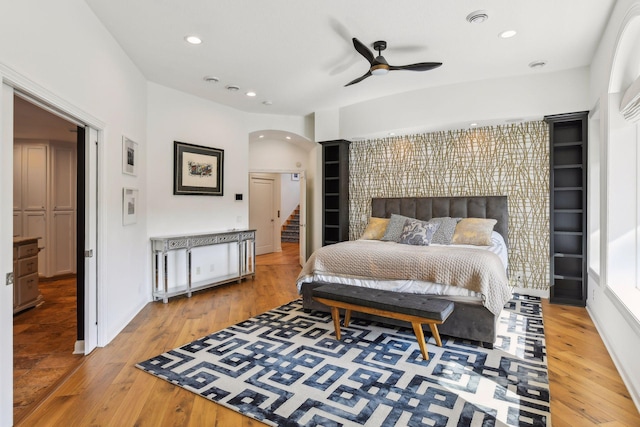 bedroom with wood-type flooring and ceiling fan