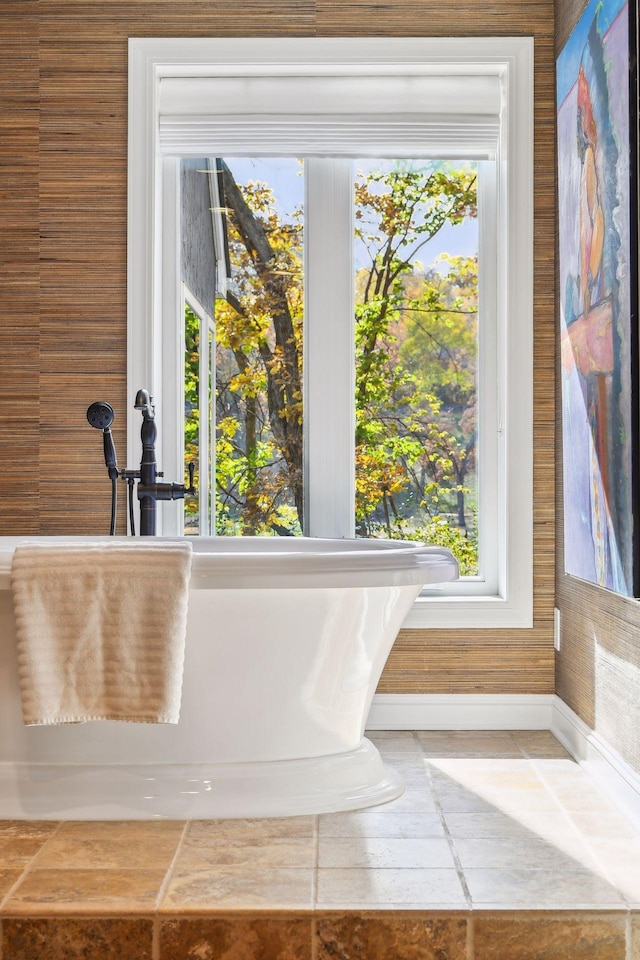 bathroom with a bath and plenty of natural light